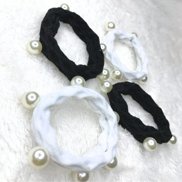 Pearl Hair Tie Set of 4, Set of four fabric hair ties in black and white, each decorated with round faux pearls, displayed on a soft white surface.