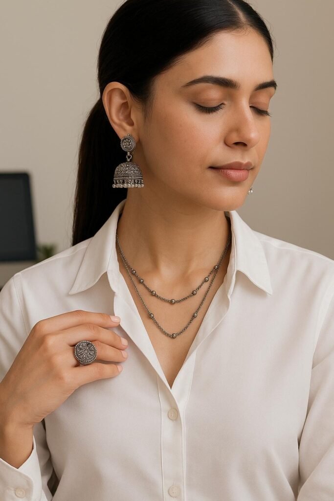 4 Effortless Ways to Wear Oxidised Jewellery to the Office | Avvni The Store woman wearing elegant oxidised silver jhumka earrings, layered necklaces, and a statement ring with a white shirt, showcasing minimalist office jewellery styling. 5 Effortless Ways to Wear Oxidised Jewellery to the Office
