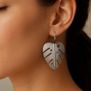 Close up of model wearing palm leaf oxidised earrings