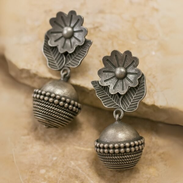 Flatlay Detailed view of floral motif and beadwork on oxidised jhumki.