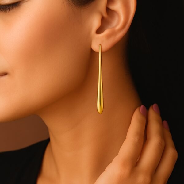 Gold Long Tear Drop Anti Tarnish Earrings worn on model ear