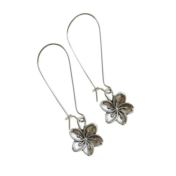 Oxidised Silver Flower Motif Dangle Earrings by Avvni Jewellery, A pair of silver flower dangle earrings with long hooks displayed on white background.