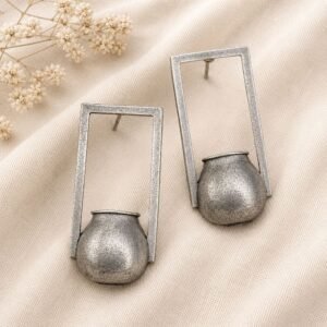 Close-up of detailed oxidised silver tribal pot drop earrings
