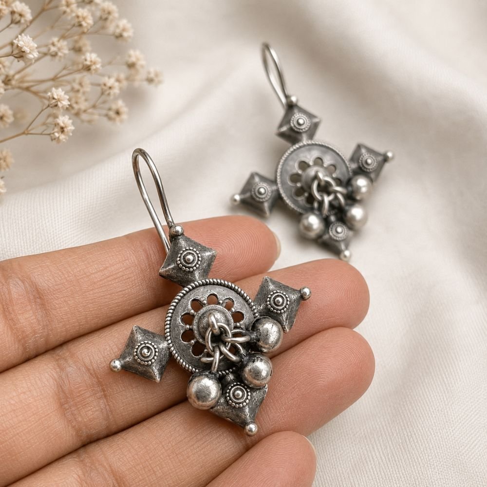 Avvni Oxidised Silver Tribal Drop Earrings | Avvni The Store Handheld view of detailed Oxidised Silver Tribal Drop Earrings