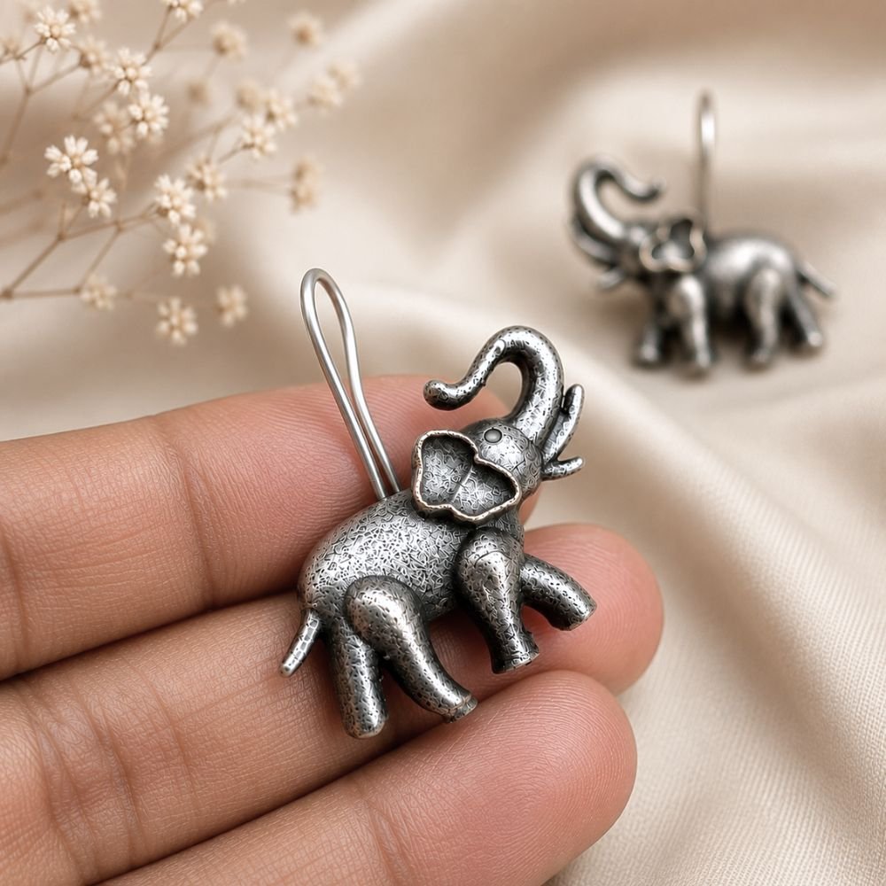 Avvni Oxidised Silver Elephant Drop Earrings | Avvni The Store Handheld Close-up of detailed oxidised silver elephant drop earrings
