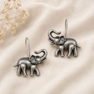 Close-up of detailed oxidised silver elephant drop earrings