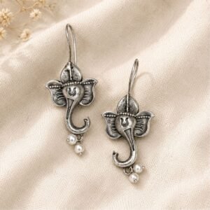 Close-up of detailed oxidised silver Ganesha pearl earrings