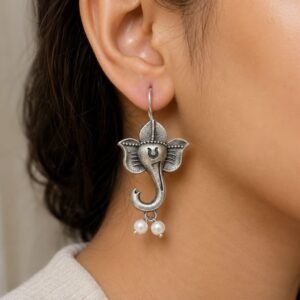 The Fascinating Role of Oxidised Jewellery in Ancient Civilizations | Avvni The Store Model wearing oxidised silver Ganesha pearl drop earrings Caption