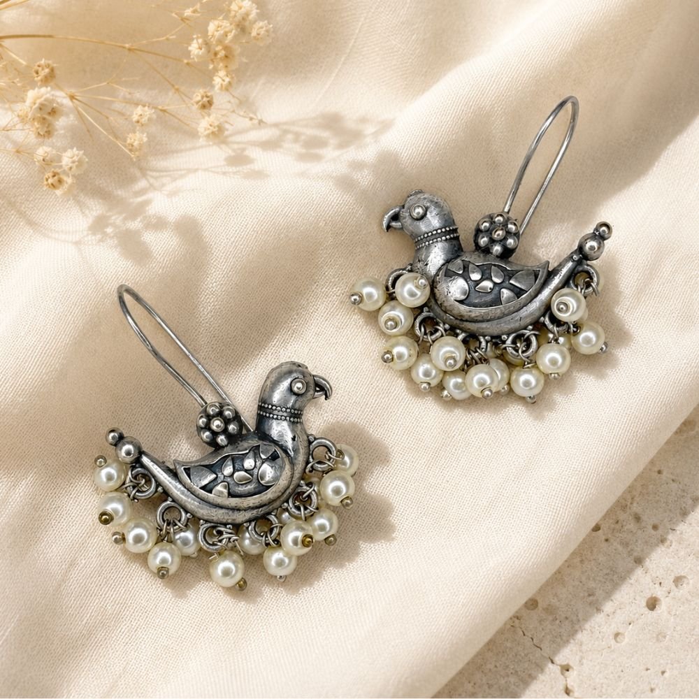 Avvni Oxidised Silver Peacock Pearl Drop Earrings | Avvni The Store Close view of oxidised silver peacock pearl drop earrings with hook closure