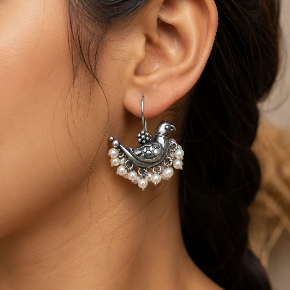 Avvni Oxidised Silver Peacock Pearl Drop Earrings | Avvni The Store Model wearing oxidised silver peacock pearl drop earrings with ethnic outfit
