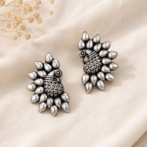 Flat lay Close-up of intricate peacock design on Oxidised Silver Peacock Stud Earrings