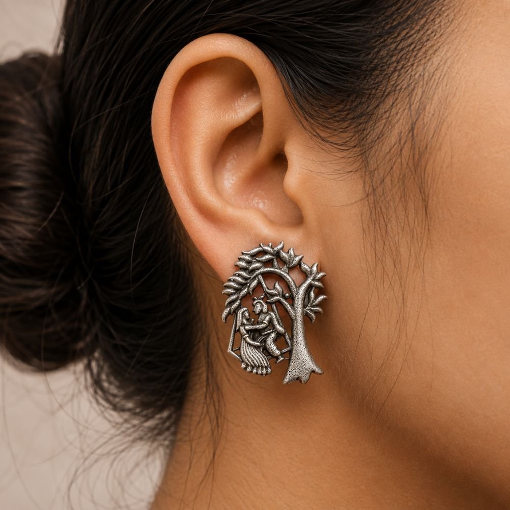 Avvni Oxidised Silver Radha Krishna Stud Earrings | Avvni The Store Oxidised Silver Radha Krishna Stud Earrings Close-up view on model's ear