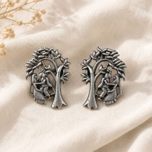 Flat lay Close-up of Oxidised Silver Radha Krishna Stud Earrings with intricate detailing